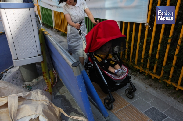 유모차를 끄는 육아맘이 서울시 내 한 초등학교 통학로 정비공사 현장에서 통행에 불편함을 겪고 있다. 김재호 기자 ⓒ베이비뉴스